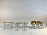 seven wine glasses and a vase on the table