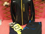 black and yellow jacket and pants on a bed with a pink blanket