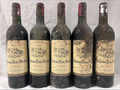 six bottles of wine are lined up in a row on a table