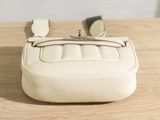 a white purse sitting on top of a wooden table