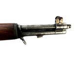 a close up of a rifle with a wooden handle on a white background