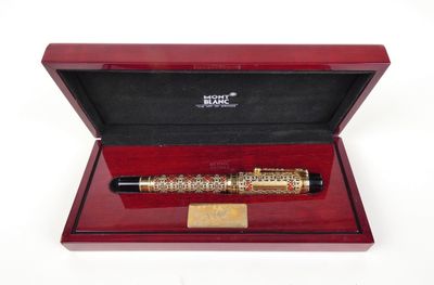 an image of a pen in a wooden box on a white surface