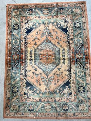 an antique persian rug with a blue and orange design