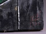 a close up of a piece of art with a clock on it