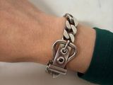 silver chain bracelet with a clasp on a woman ' s wrist