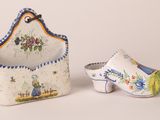 pair of ceramic shoes and a purse on a white surface