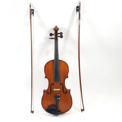 an old violin sitting on top of a white surface
