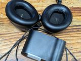 two headphones and a mp3 player on a wooden table