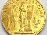 a close up of a gold coin on a white surface
