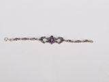 a close up of a bracelet on a white surface