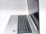 a laptop computer sitting on top of a white table