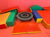a trampoline in the middle of a room with a table and chairs