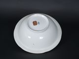 a white bowl that has a brown spot on it
