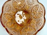 a glass bowl with a gold flower design on it