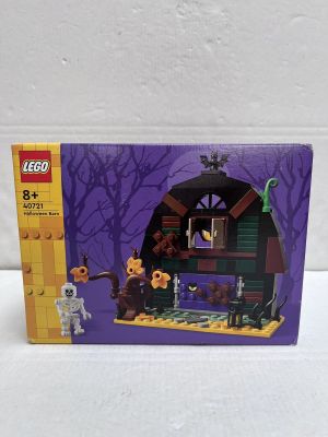 the box is open to show the contents of the lego haunted house