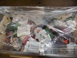 a plastic bag full of assorted toys on a table