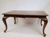 an image of a wooden table with two leaves on it