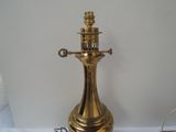 a gold lamp that is sitting on a table