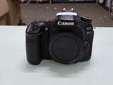 a canon camera sitting on a table in a room