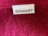 a close up of a label on a pink blanket that says damart