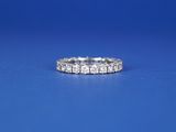 a close up of a diamond ring on a blue surface