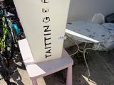 a white container sitting on top of a pink chair