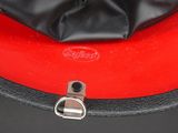a red and black cake with a bow on top of it