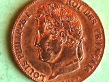 a close up of a penny on a table with a green background