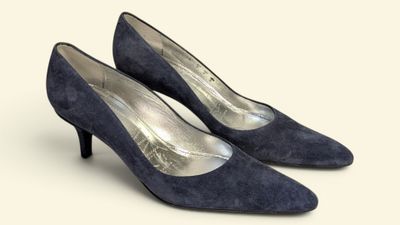 pair of women ' s blue sued shoes on a white background