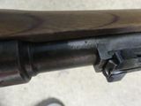 the gun is attached to the handle of a rifle on the ground