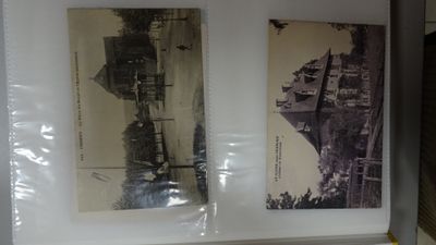 two old photos of a city on display on a shelf