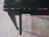 a small black table with a floral design on it