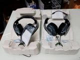 two boxes with headphones sitting on top of each other