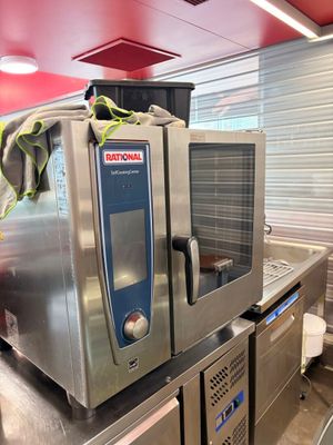 a commercial oven sitting on top of a counter in a kitchen
