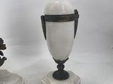 a pair of white vases sitting on top of a marble base