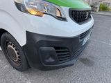 a white van with a green stripe parked in a parking lot
