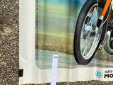 a poster of a man riding a motorcycle on the street