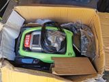 a box with a green and black vacuum in it