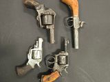 three old revolvers sitting on a table next to each other