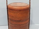 an image of a wooden basket with a handle on a white surface