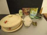 a table with a bowl, plate, spoon, and other items on it