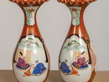 two vases that are sitting on a table