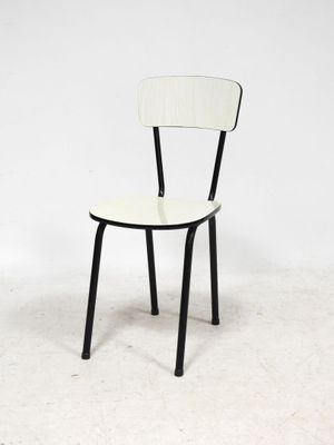 a black and white chair sitting on a white floor