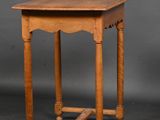 an antique oak side table with turned legs and a square top