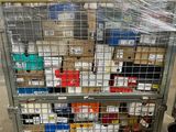 a metal cart with many boxes on it in a warehouse
