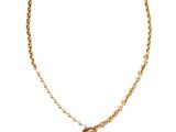a close up of a necklace with a cross on a chain