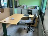 a desk with a chair in the corner of the room