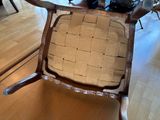 a chair that has a seat made out of a piece of wood