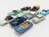 several toy cars are lined up in a row on a white surface