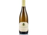 the bottle of white wine is sitting on a white surface